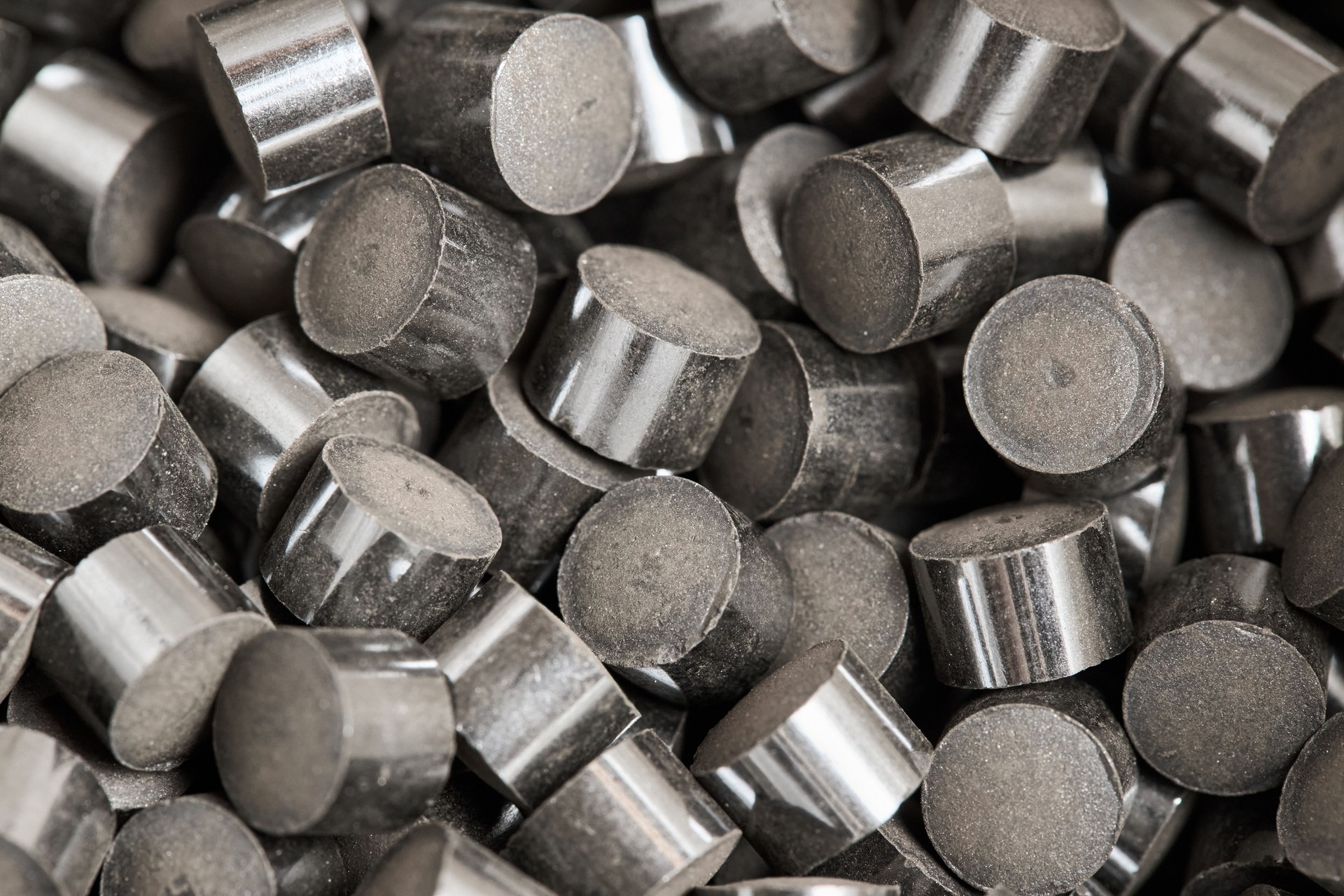 Zinc oxide chromium copper catalyst cylinder pellet form shape methanol synthesis industrial petrochemical background, selected focus close up macro shot.